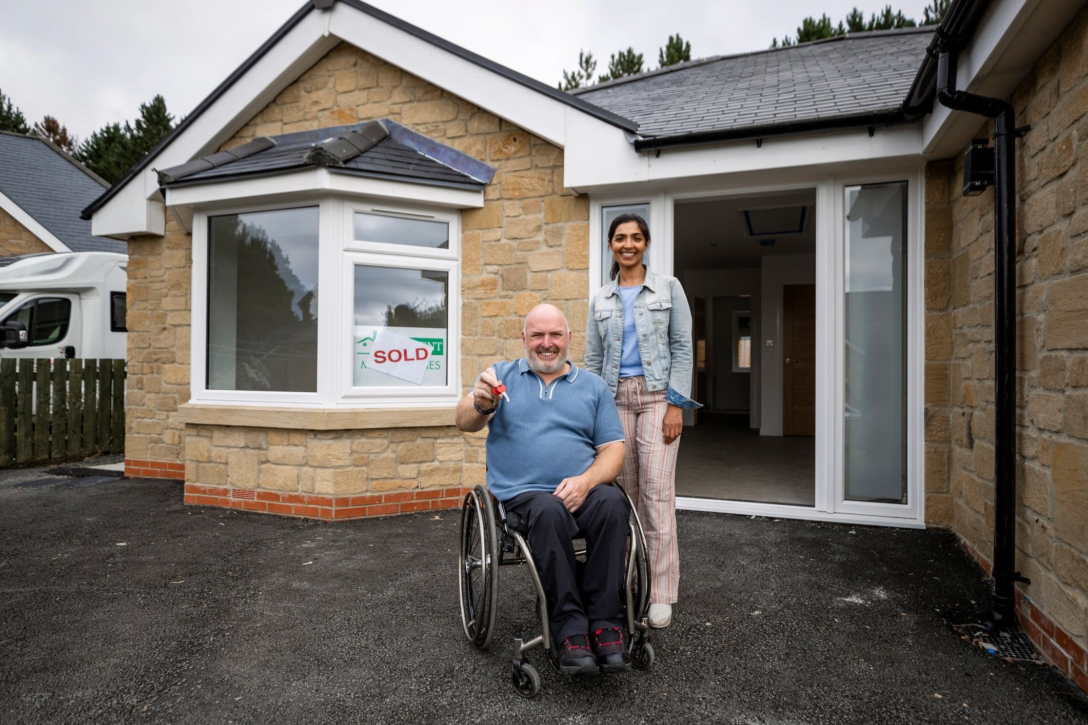 Homeowners standing outside their home