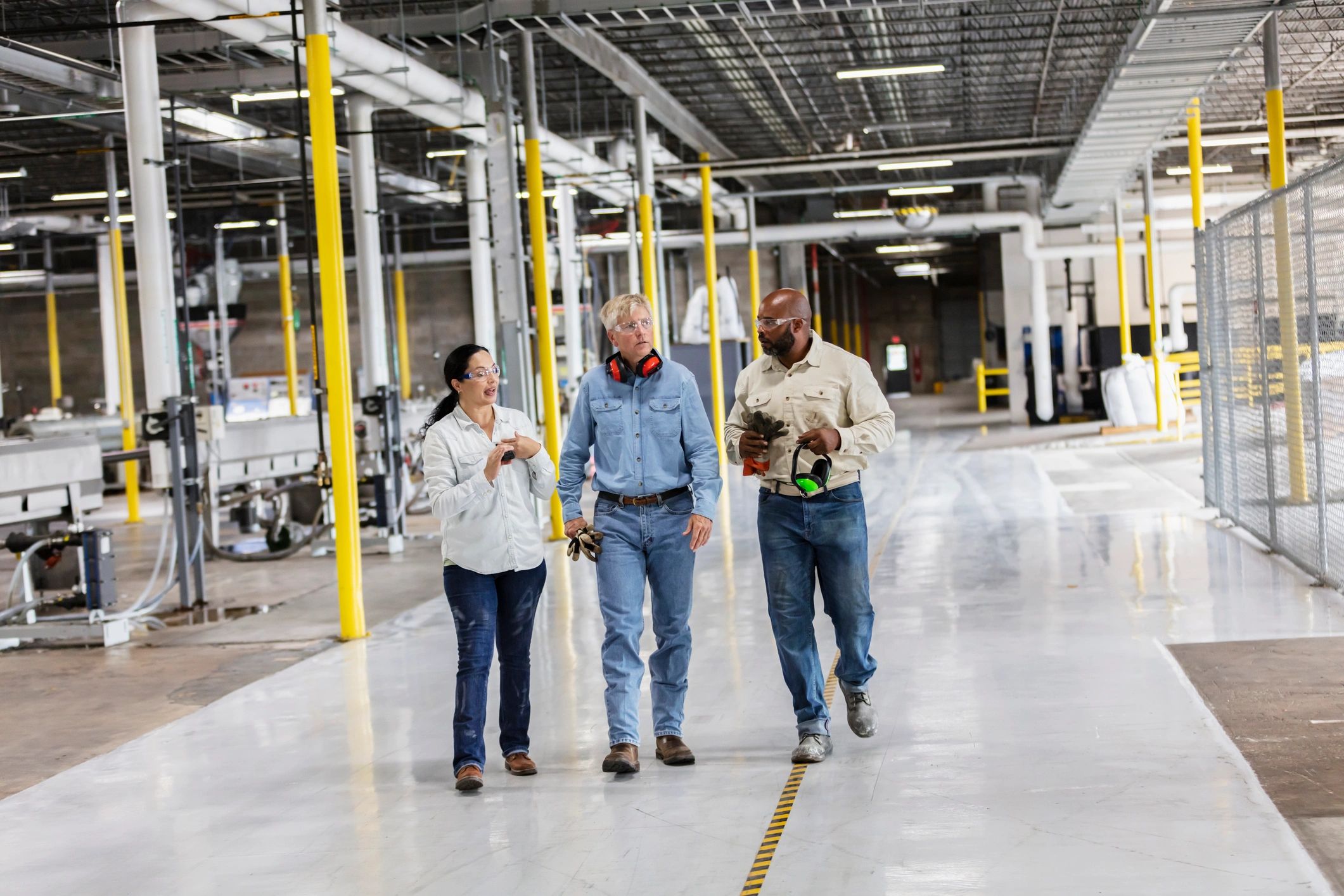 Workers walking through a factory floor